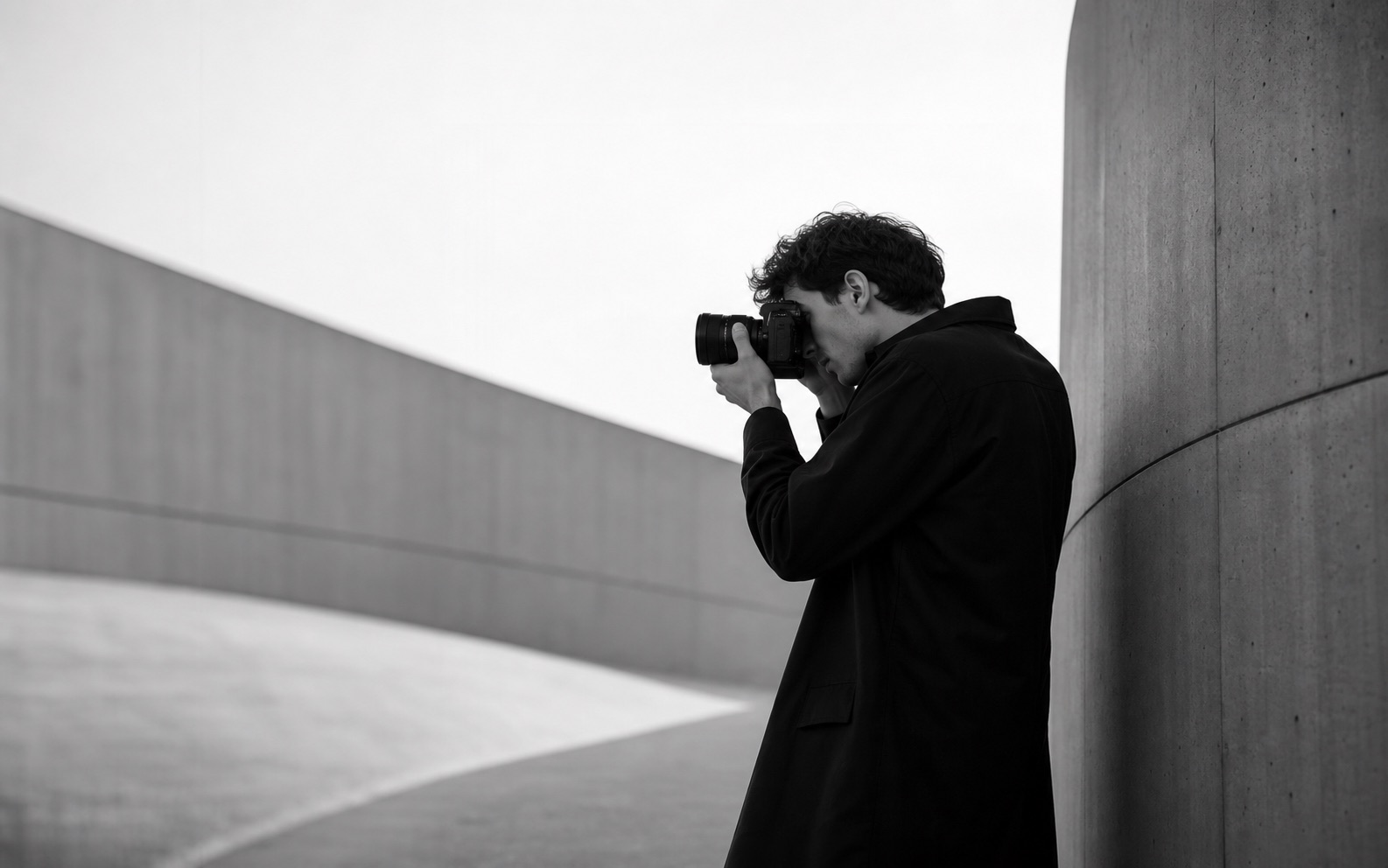 Photographer working near concrete architecture