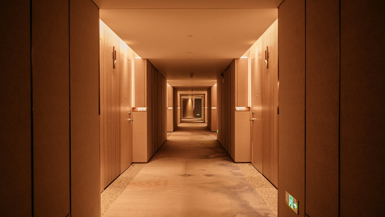 A warm-lit hotel corridor