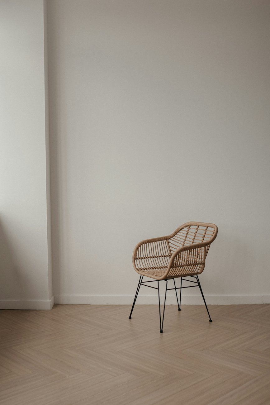 A wicker chair on a wooden floor