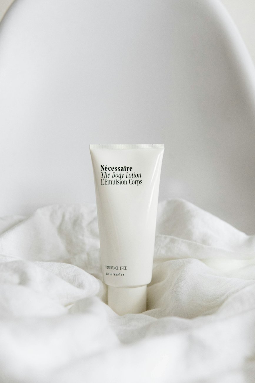 A lotion tube on white fabric